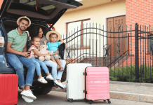family sitting in trunk of car for road trip