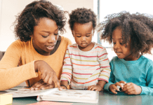 mother reading a book to her two small children