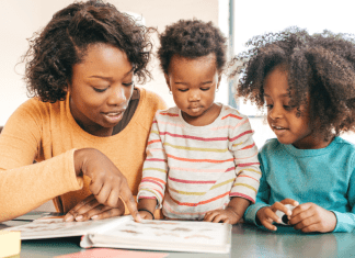 mother reading a book to her two small children