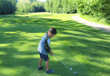 young child golfing at crystal mountain resorts