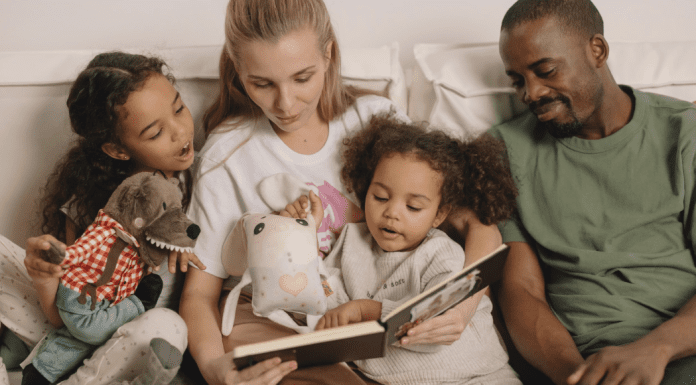 family sitting together on couch reading books