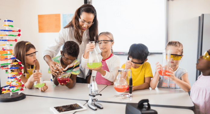 students and educator at science table