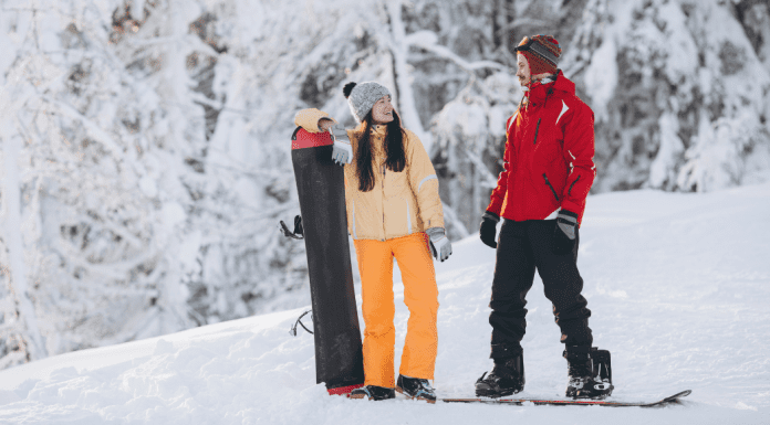 couple snowboarding in winter