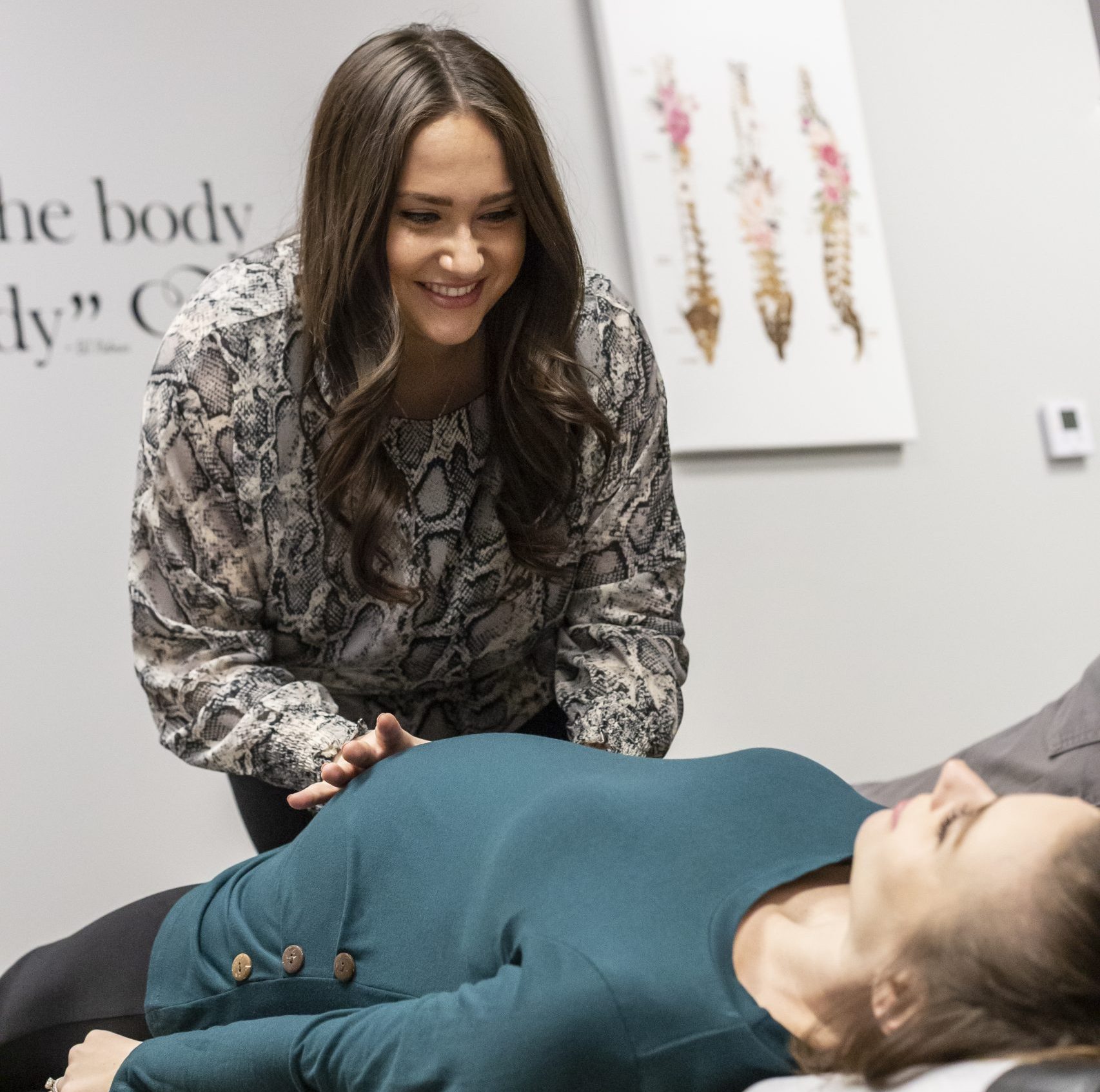 pregnant woman laying on her back receiving chiropractic care at Esssential Family Chiropractic