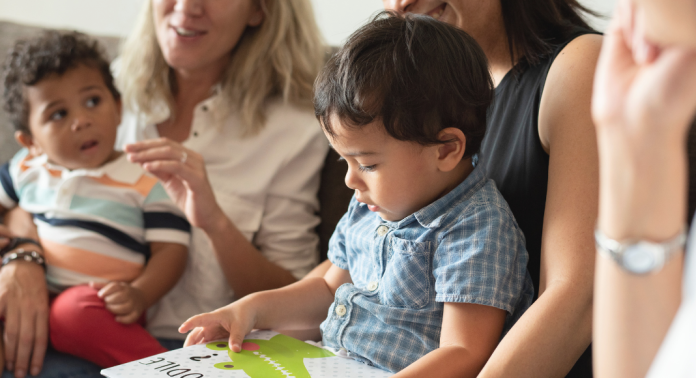 toddlers on mothers' laps at playgroup