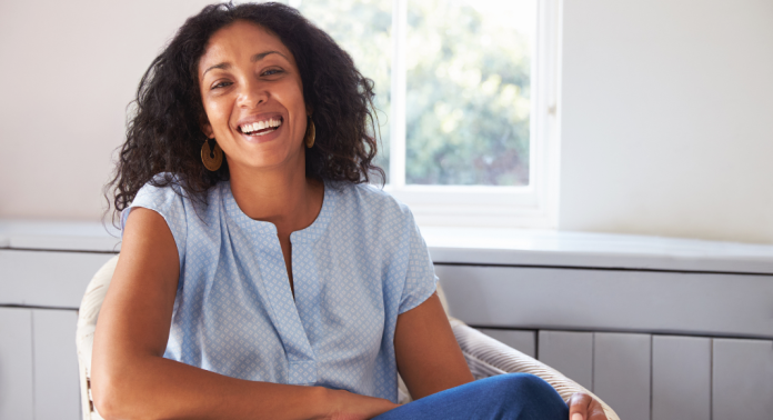 woman smiling sitting on chair